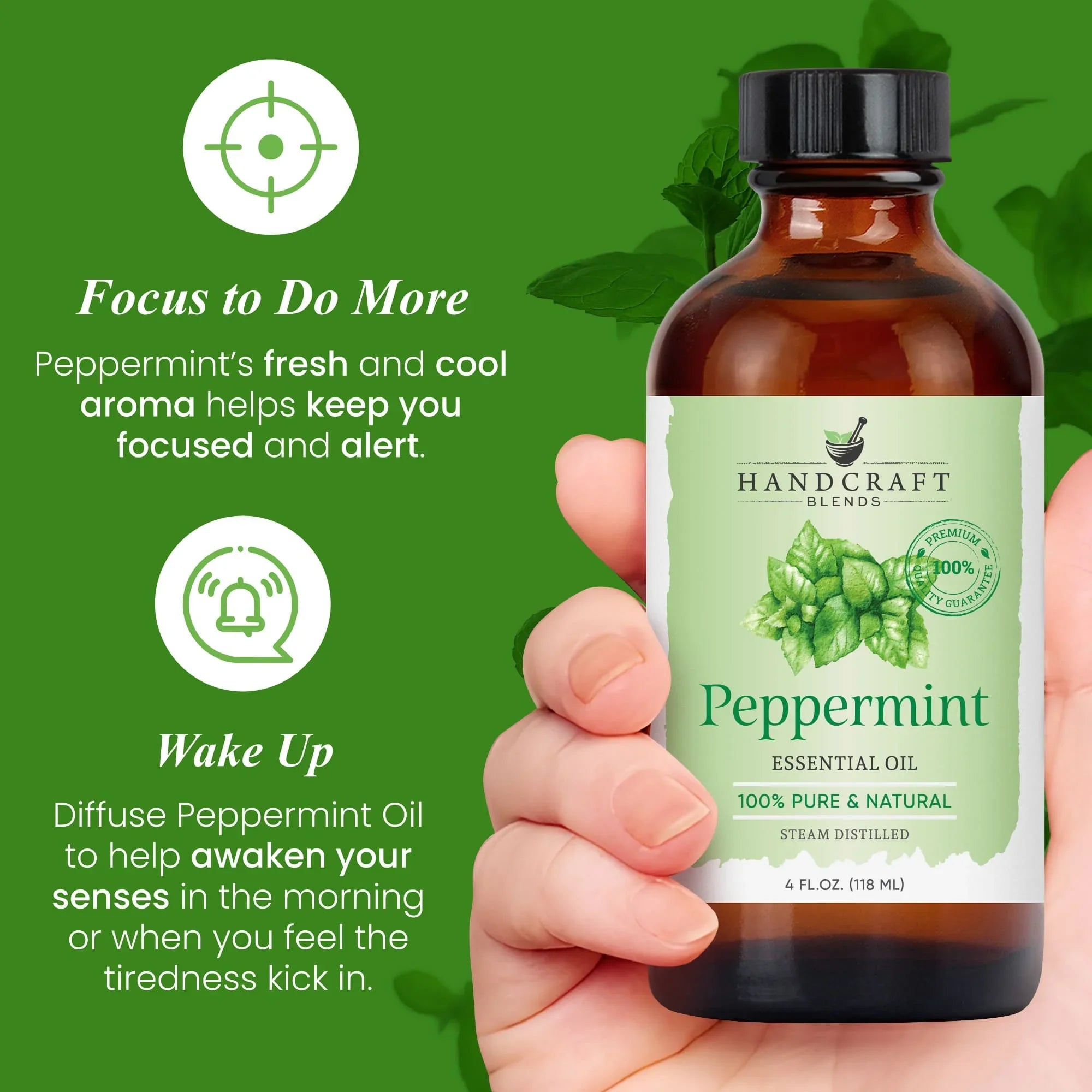 Hand holding a 4 oz bottle of peppermint essential oil with mint leaves on label and green background.