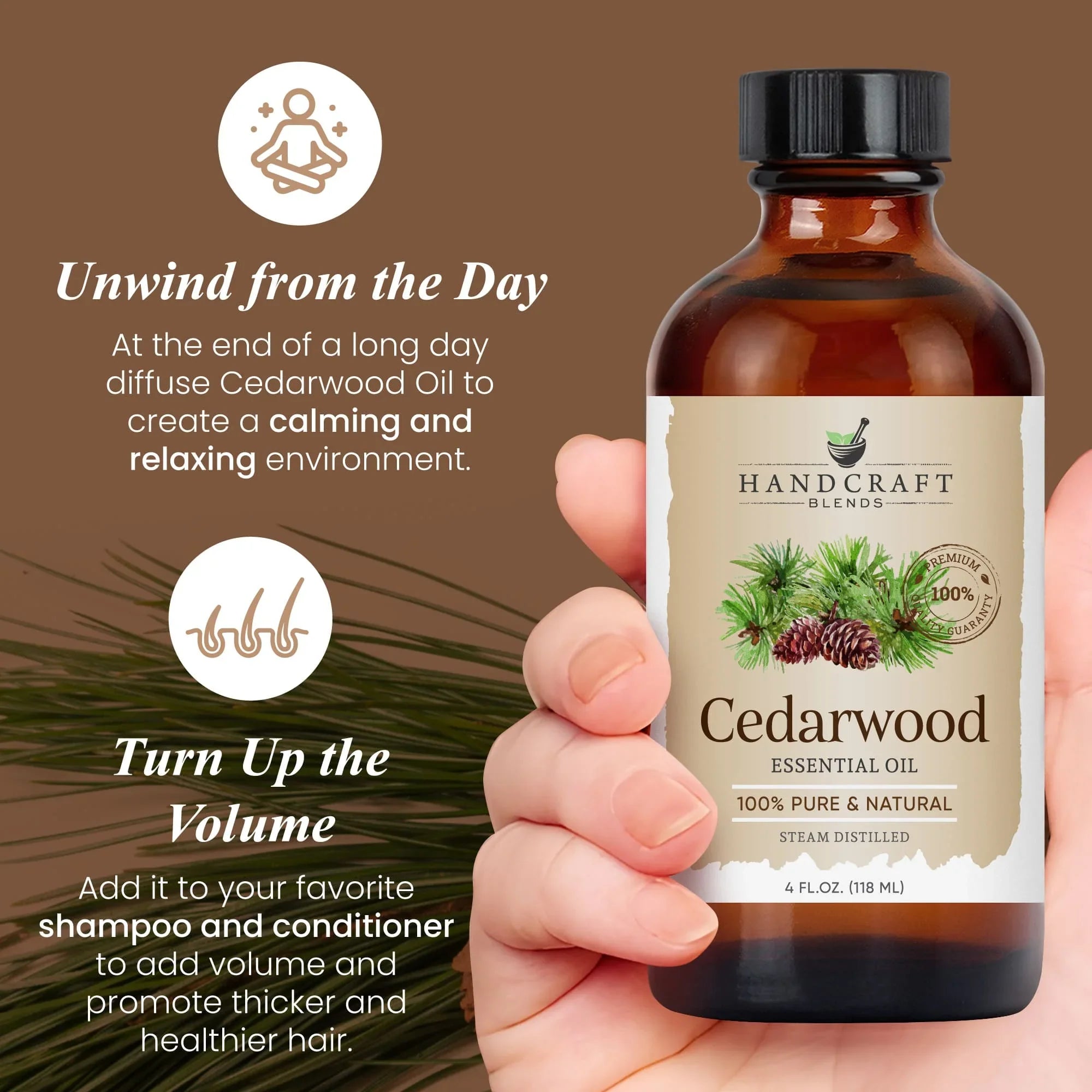 Hand holding a 4 oz bottle of cedarwood essential oil with pine cone label, brown background.
