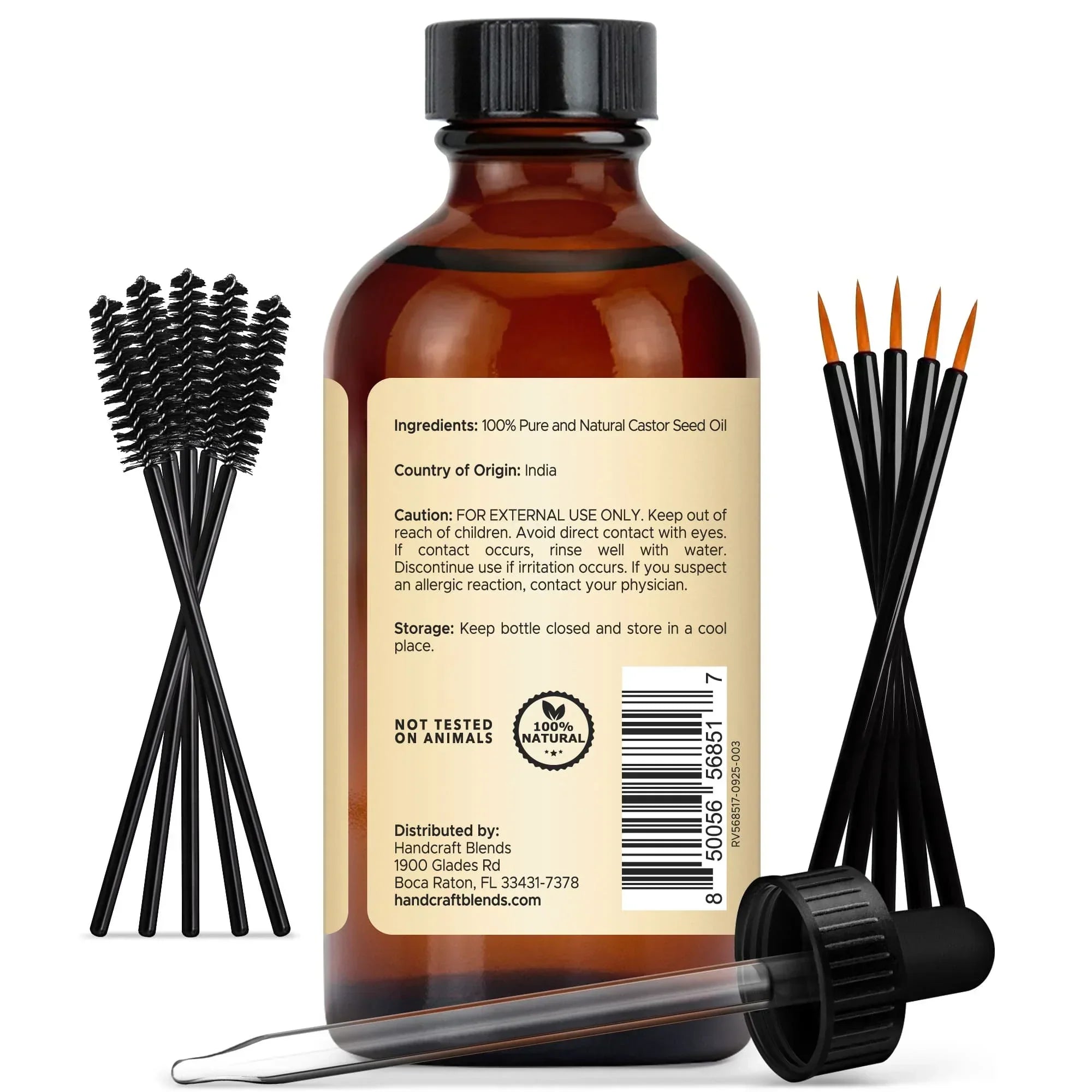 Amber glass bottle of pure castor seed oil with mascara wands, liner brushes, and dropper