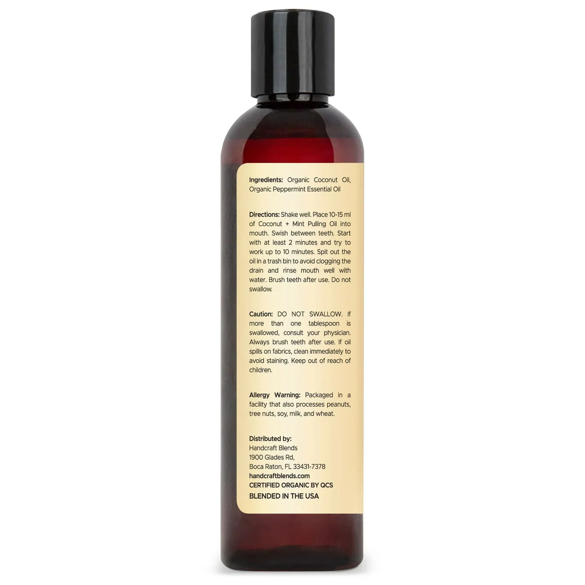 Rear view of an 8oz brown bottle with ingredient and usage label for coconut mint pulling oil.