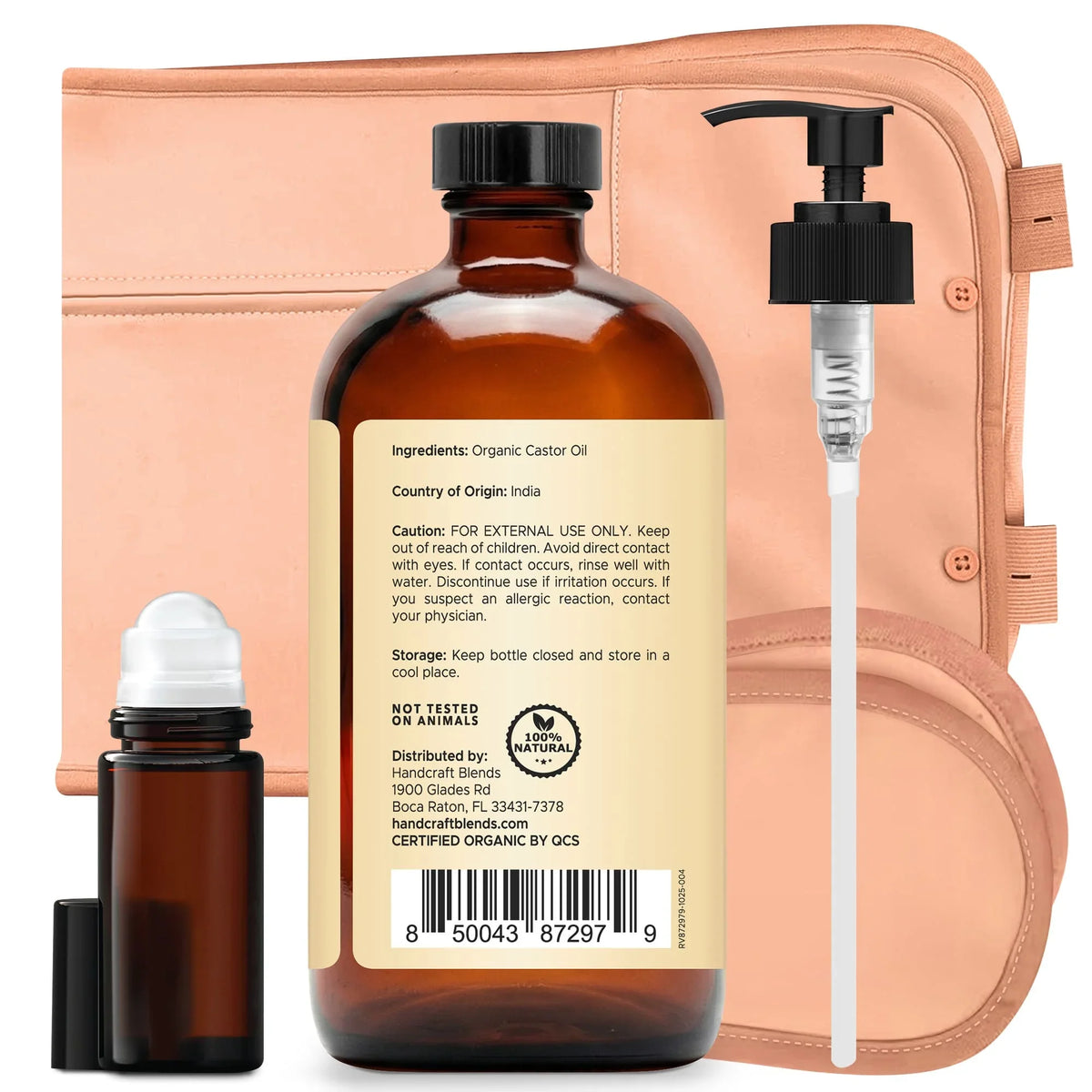 Organic castor oil bottle with pump, roller bottle, and peach-colored wrap for aromatherapy.