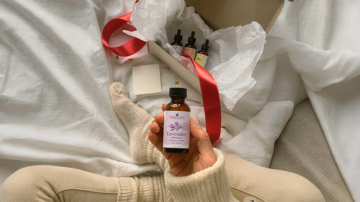 Lavender and peppermint essential oil bottles arranged as a gift with a ribbon