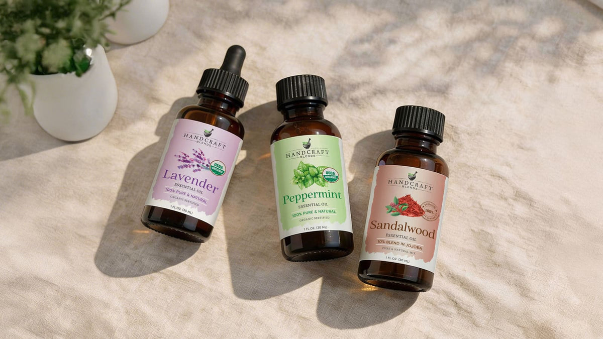 Large amber glass essential oil bottles grouped on an open wooden shelf with dried lavender and small travel vials