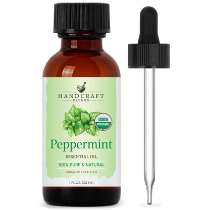 Amber bottle of organic peppermint essential oil with dropper and green mint leaf label
