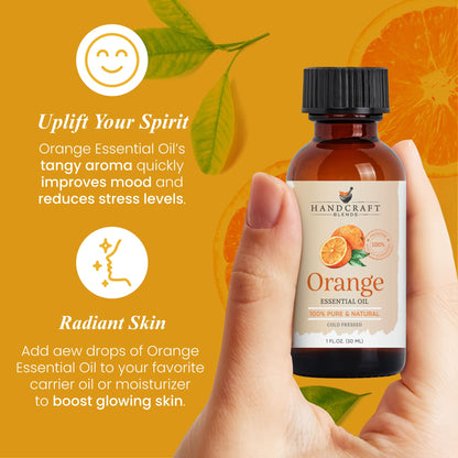 Hand holding a bottle of orange essential oil with orange slices and green leaves on an orange background, highlighting mood and skin benefits.