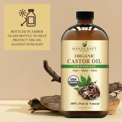 Amber glass bottle of organic cold pressed castor oil for hair, nails, and skin with natural decor.
